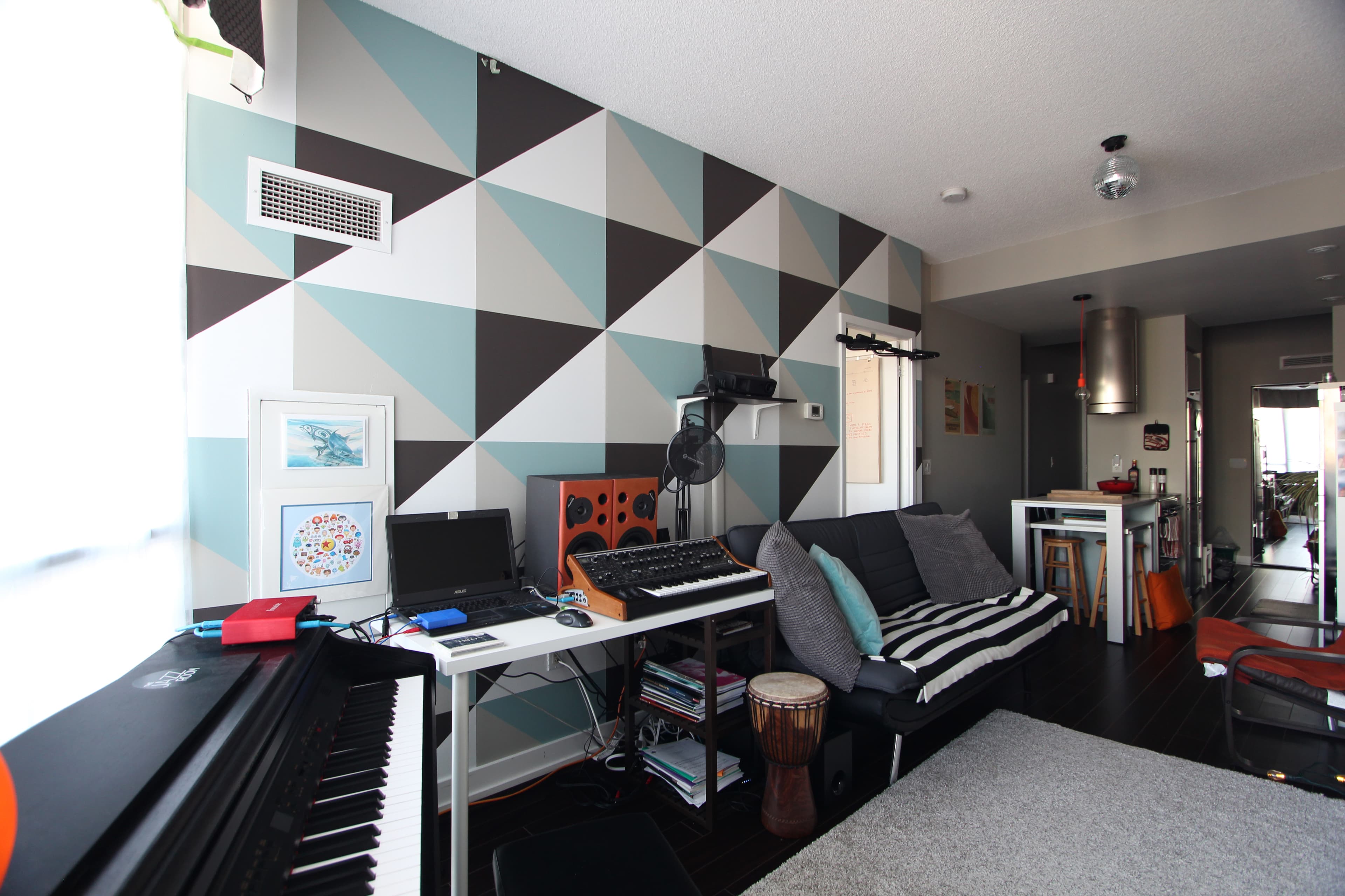 Geometric mural by Elevate Form in a residential living room — Dan Leckie commission.