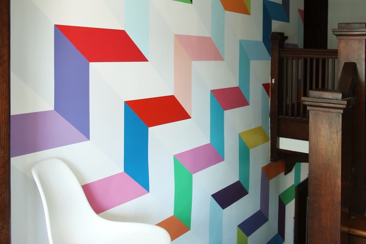 Chromatic Ascent — the same staircase wall after the mural was painted.