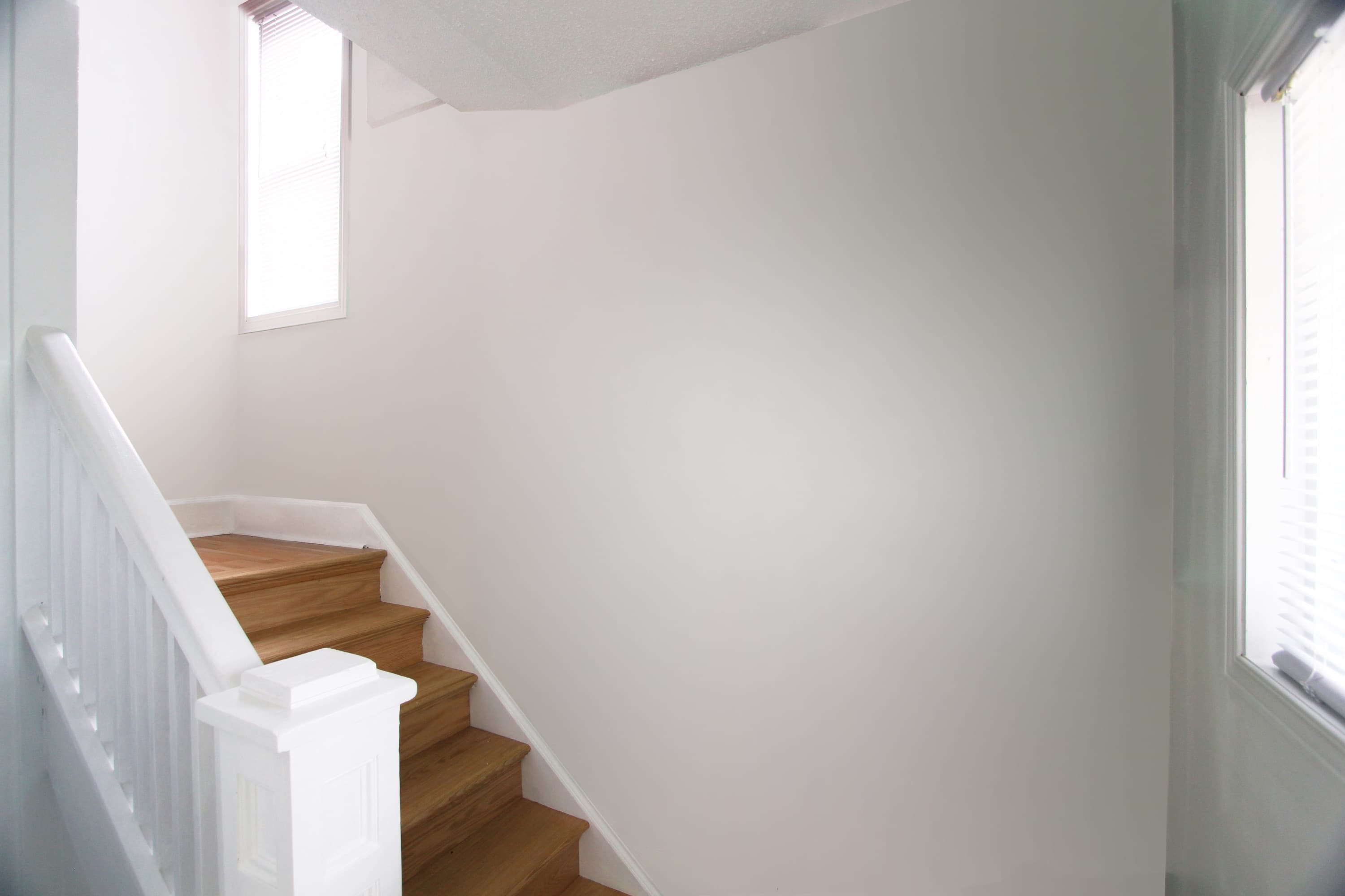 Mint & Vermillion — the stairwell wall before the mural was painted.